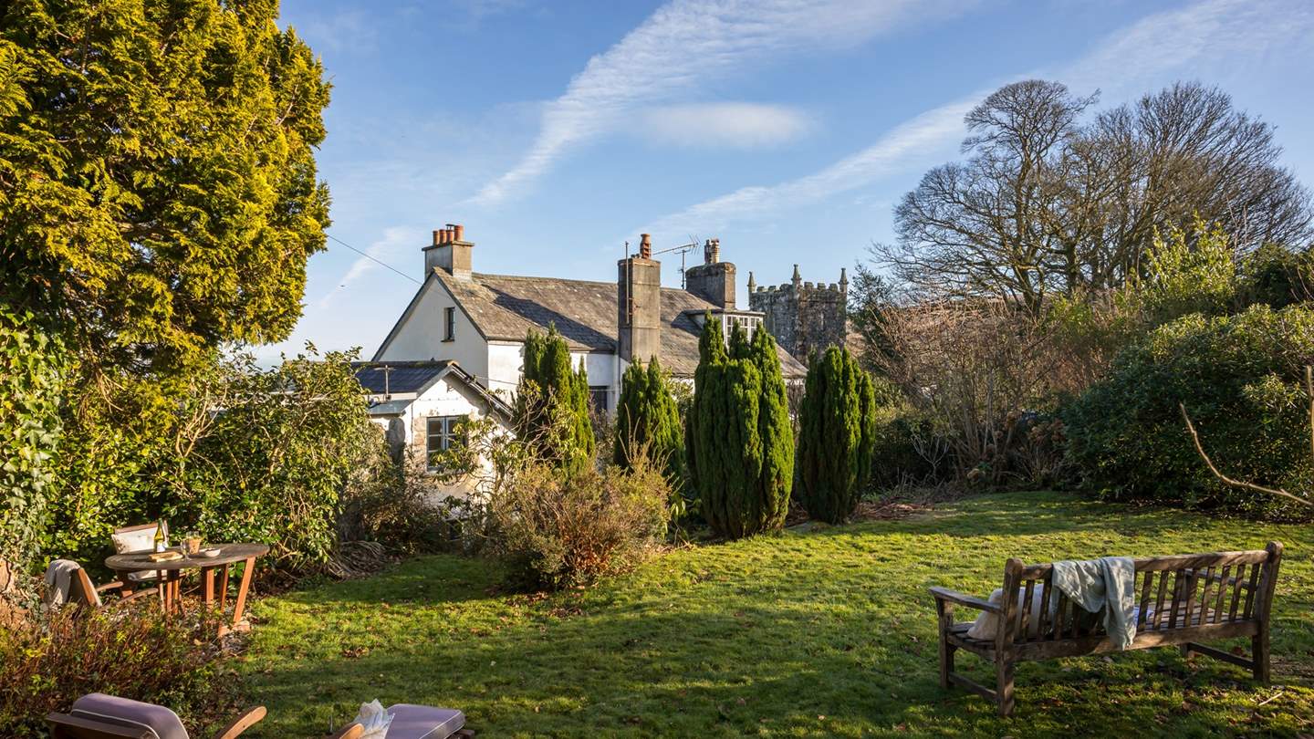 The large garden opens out onto verdant mossy lawns, colourful flower beds and fruit trees