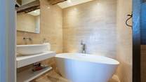 The master en suite bathroom has a gorgeous freestanding bath tub