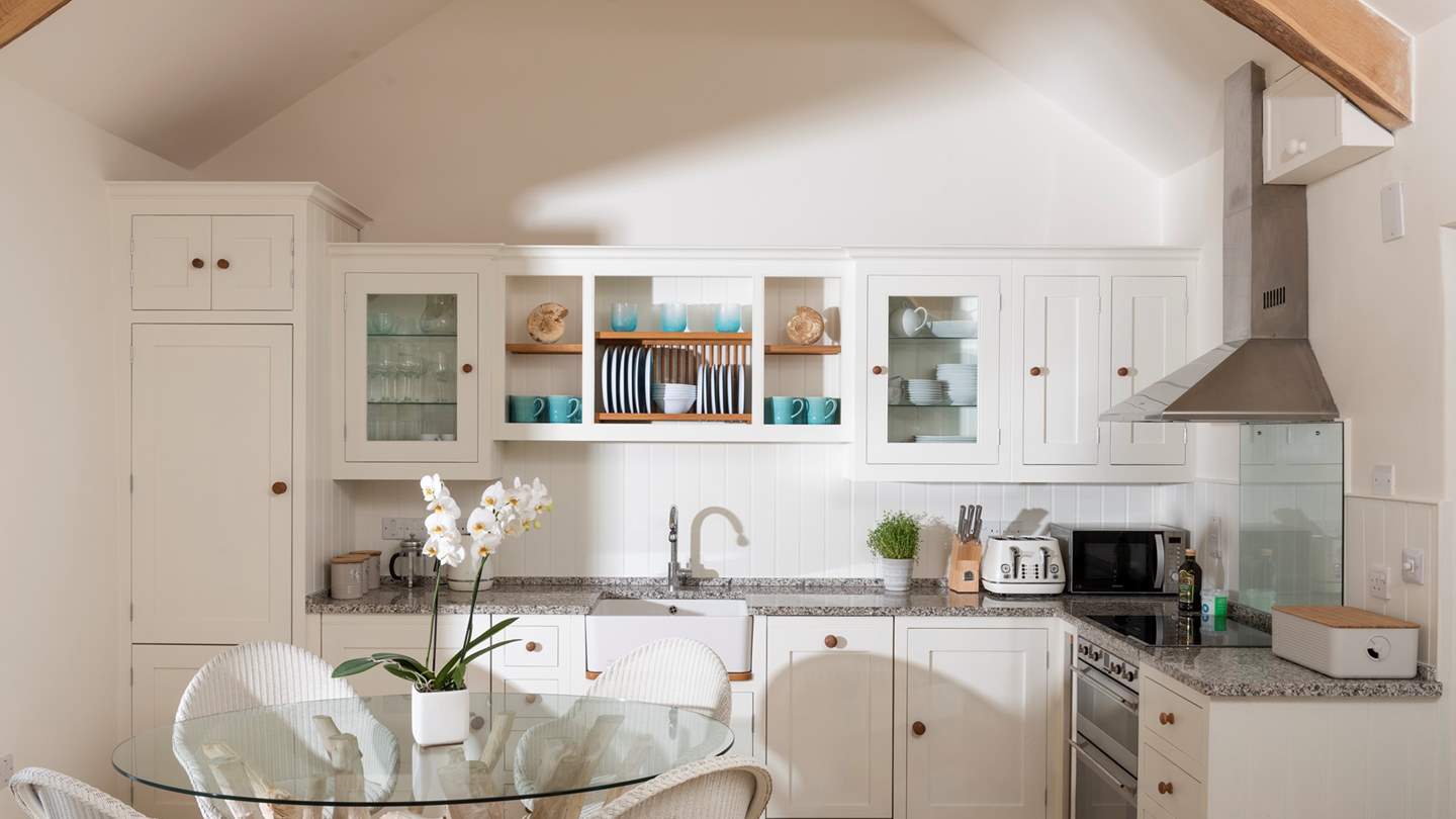 The delightful bespoke kitchen has all the bits and pieces you'll need to cook up a storm while gazing out to sea. Gorgeous granite worksurfaces line the kitchen
