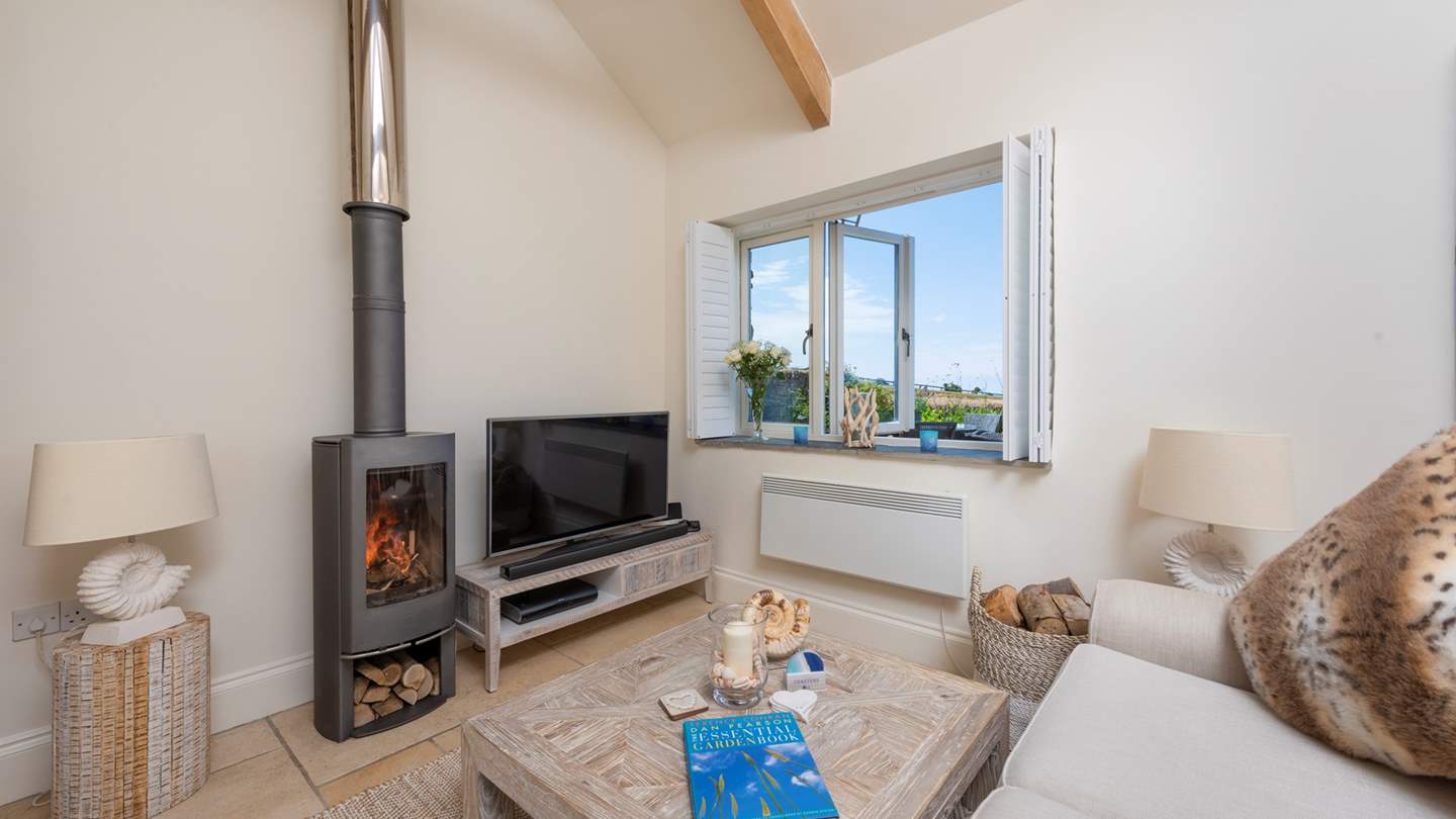 The flickering wood burner adds cosiness on cooler days - perfect whilst lounging on the sofa