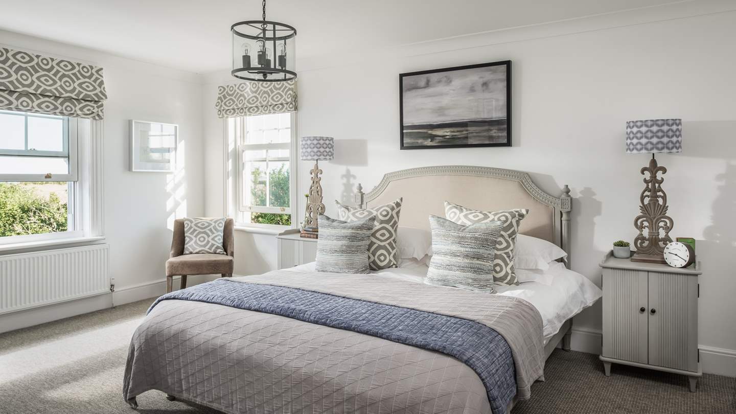 The exquisite master bedroom has dual-fronted windows, sea views and an extremely comfy super king bed - just made for lazy lie-ins!