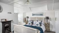 The second bedroom, in pretty shades of blue and white, overlooks the gardens and countryside.