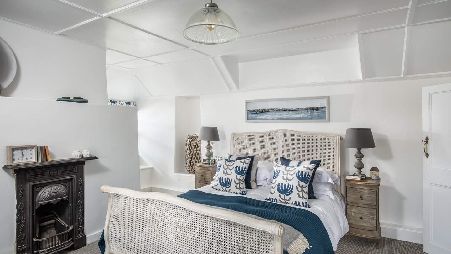 The second bedroom, in pretty shades of blue and white, overlooks the gardens and countryside.