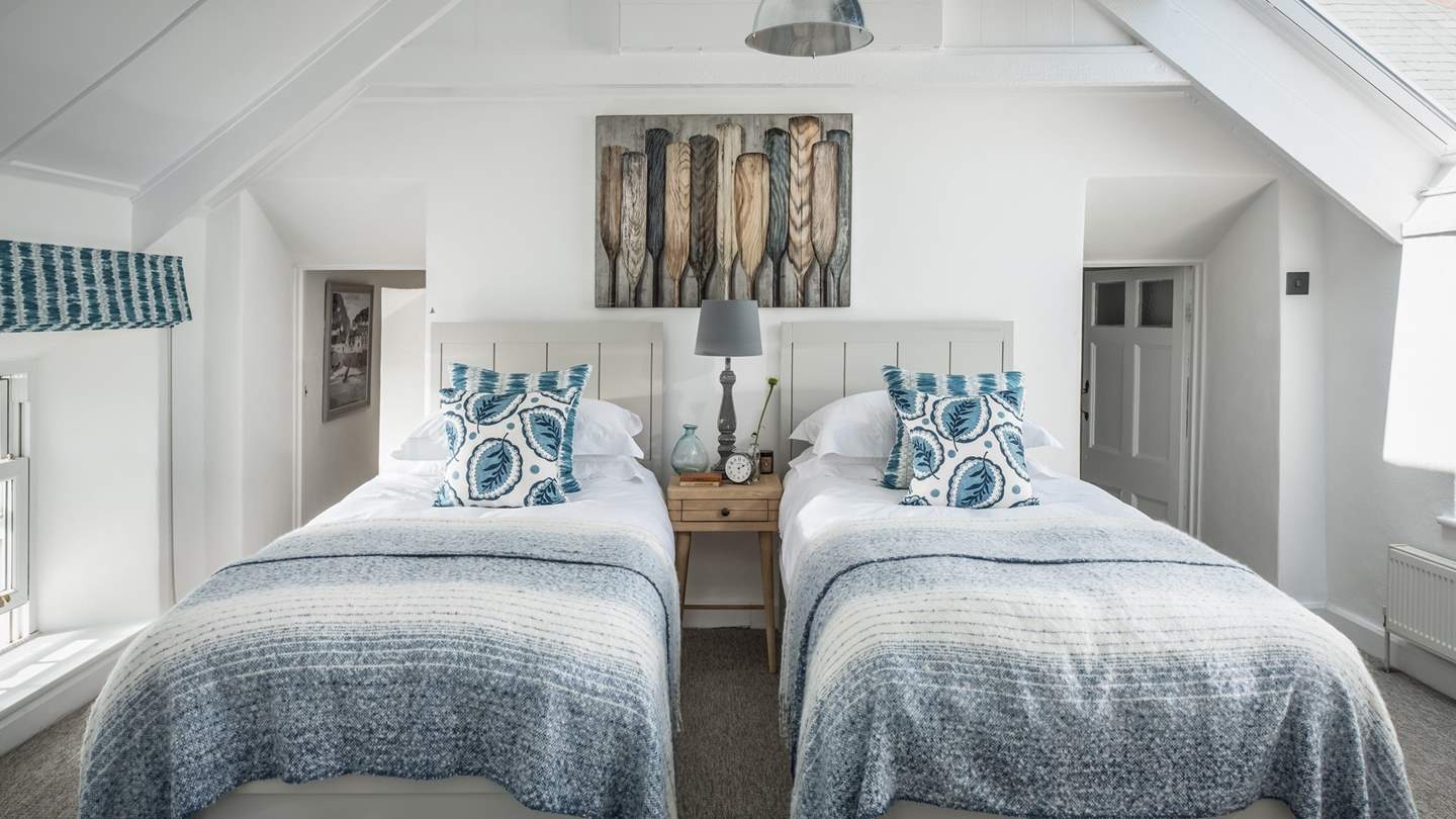 The pretty twin bedroom, with high, vaulted ceiling, is a peaceful room and perfect for little ones.