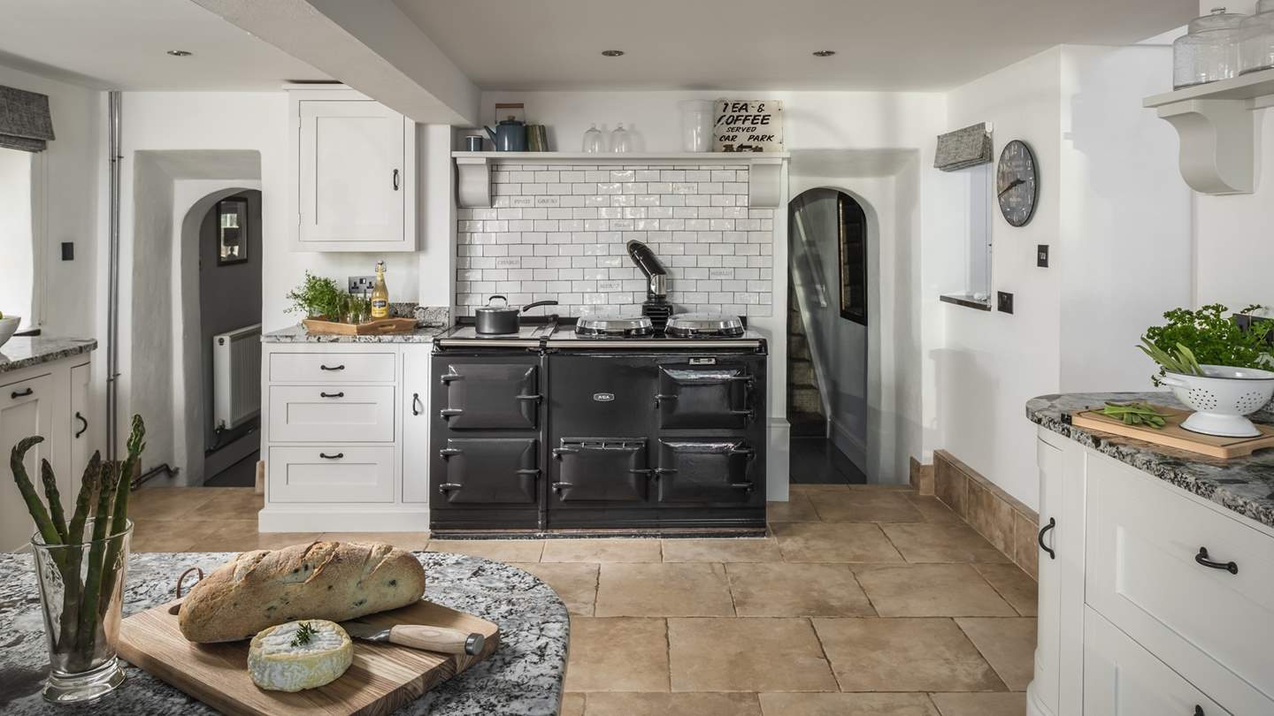 The large kitchen is jam-packed with everything you need to rustle up tasty meals, and we just love the eye-catching Aga at its heart!