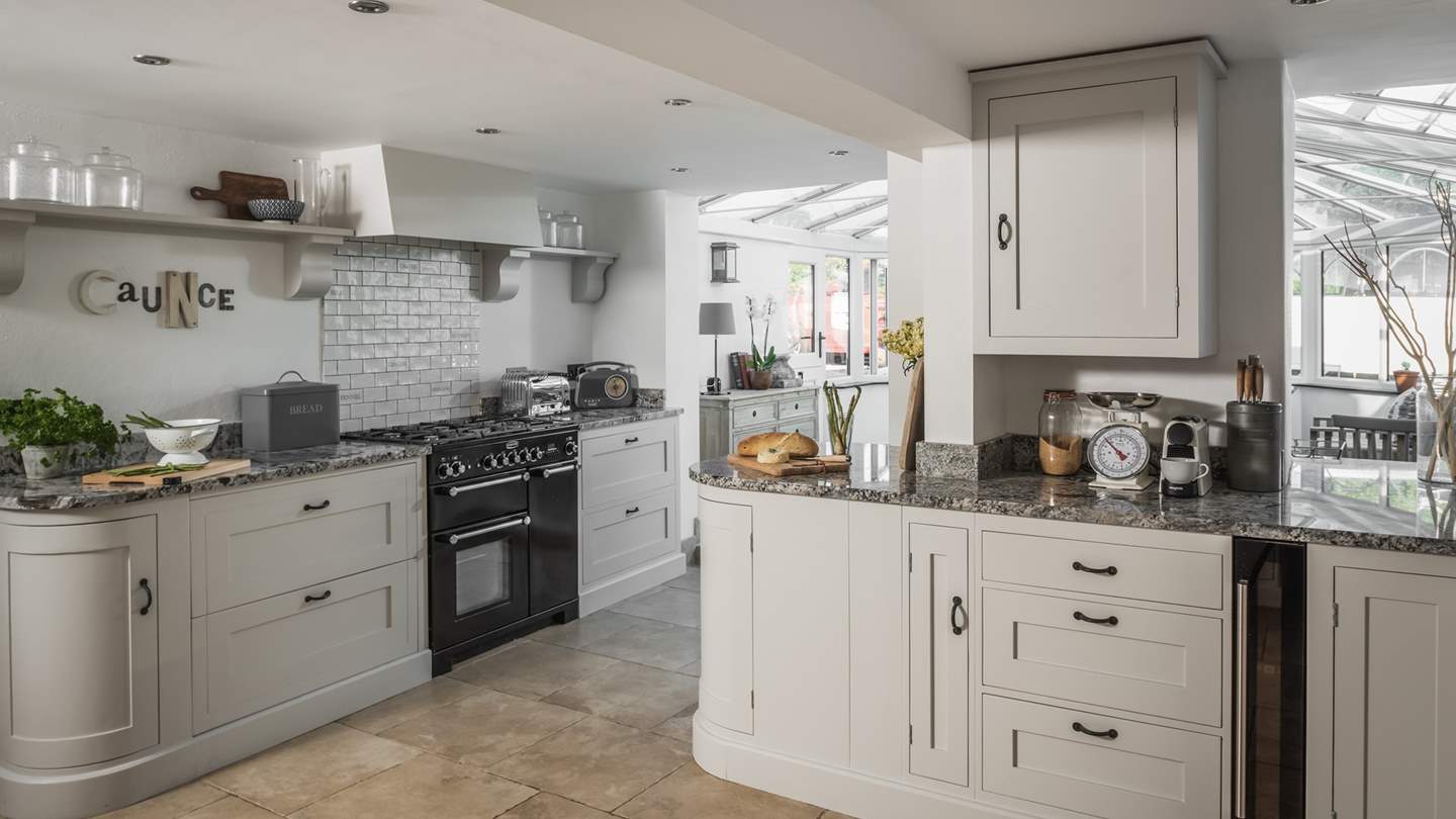 The huge kitchen is incredibly spacious and leads into the pretty conservatory.
