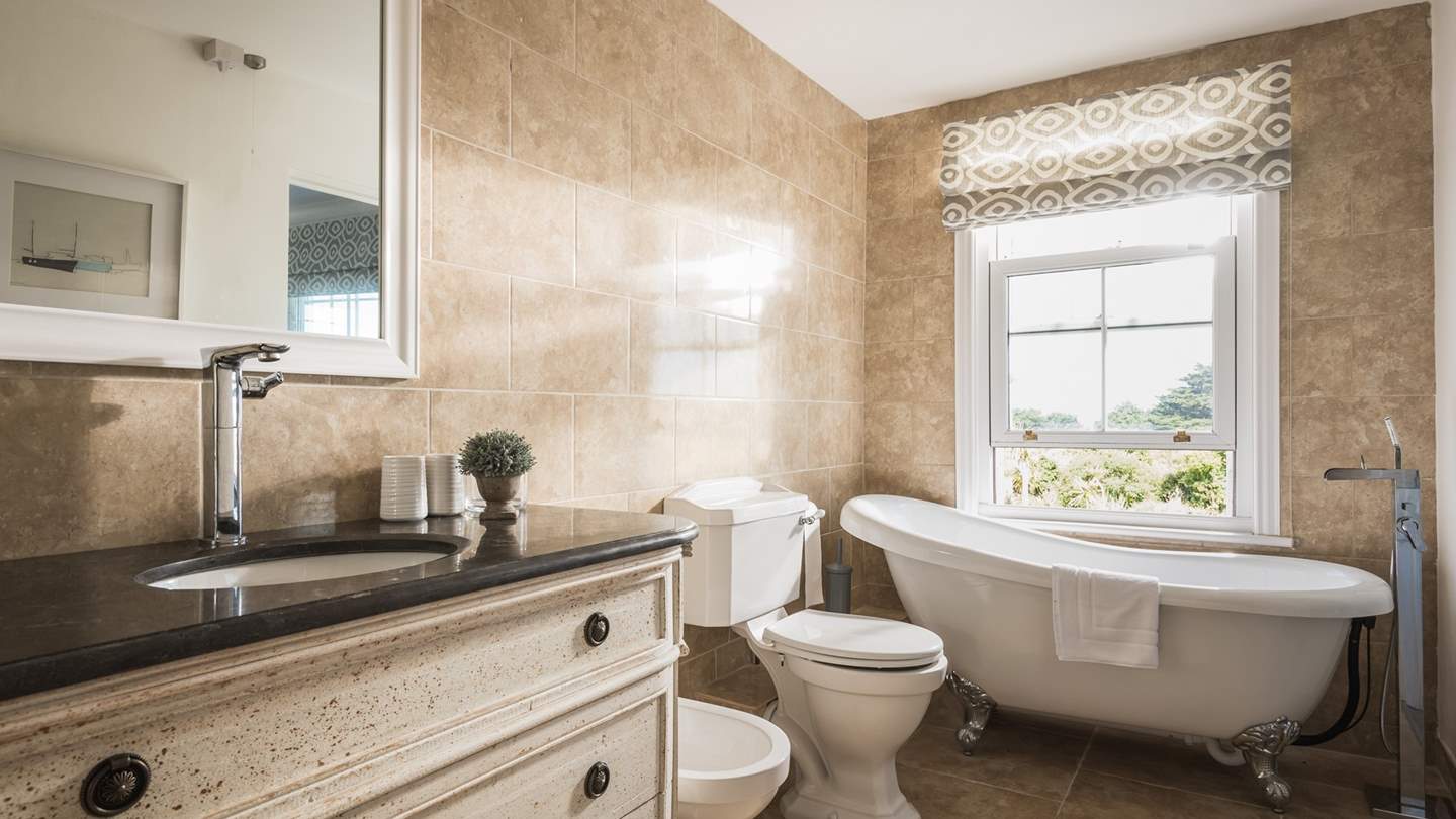 The master bedroom en suite has a lovely tub for baths - and you can look out to sea at the same time!