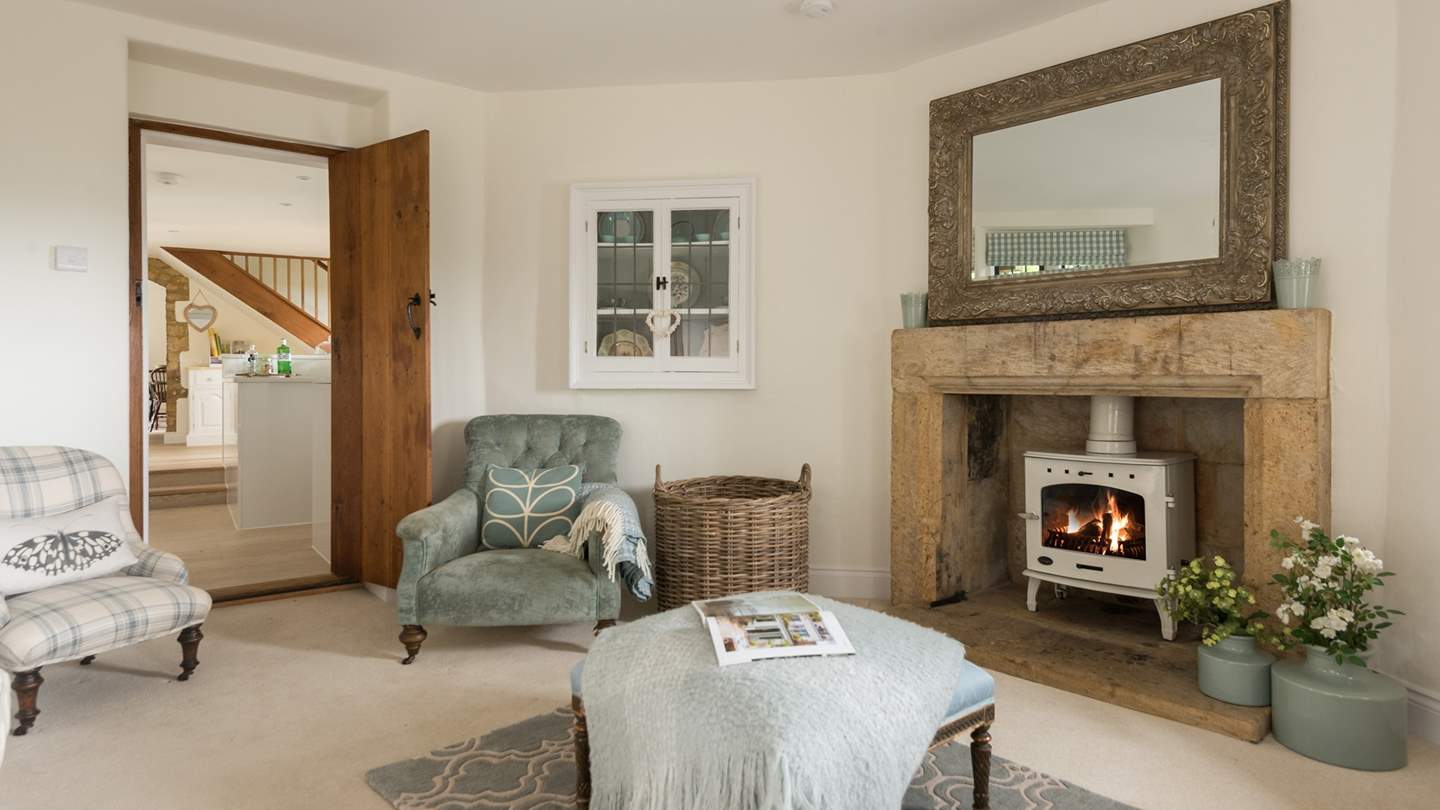 The pretty cream wood burner matches perfectly with the blue tones of this gorgeous sitting room. 