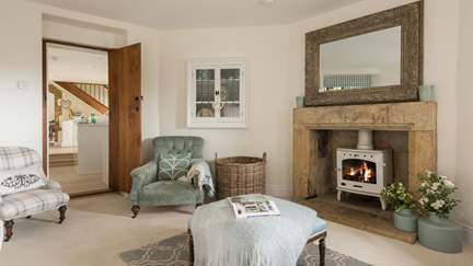 The pretty cream wood burner matches perfectly with the blue tones of this gorgeous sitting room. 