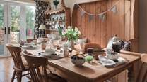 The kitchen is a lovely space with a real country feel with a period dresser, country-style dining table and seating for eight
