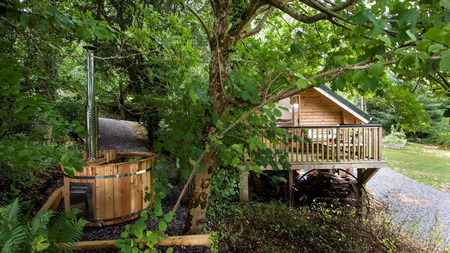 Nestled amongst the tress, this wooden retreat is a country idyll for couples.