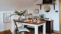 the sweet dark wooden dining table is made for long, loving dinners together