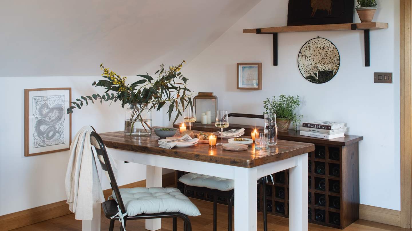 the sweet dark wooden dining table is made for long, loving dinners together