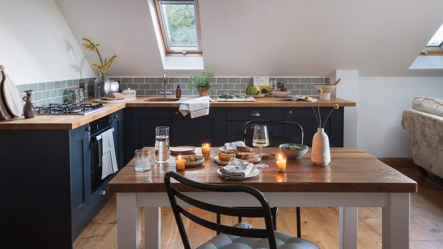 The main living space is large and spacious, with the seating area and large wood burning stove at one end and the kitchen at the other