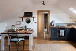 The kitchen, with gorgeous dark blue cabinets and sleek wooden worksurface, holds everything you need to create romantic meals for two 