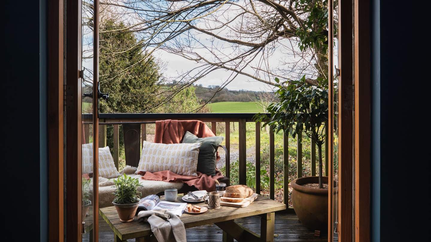 Stable doors open out onto a balcony where you're met by a verdant canopy of trees