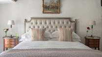 We just love the pale pinks, creams and golds used in the master bedroom.