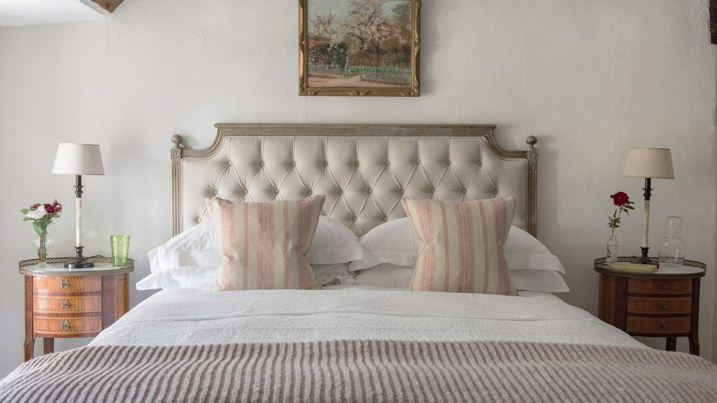 We just love the pale pinks, creams and golds used in the master bedroom.