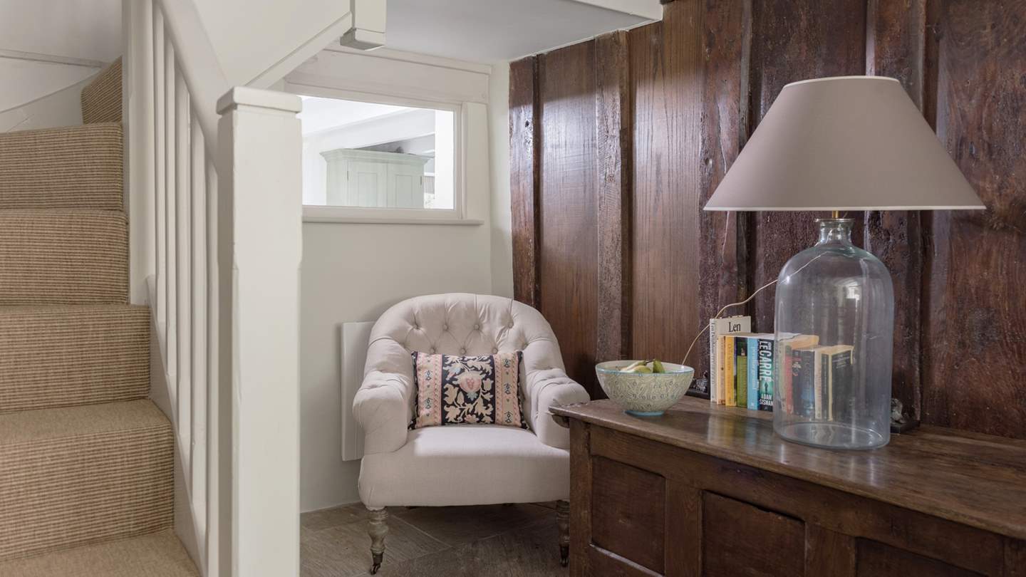 Tucked away next to the 17th century plank and muntin wooden screen, this is a corner for curling up with a good book.