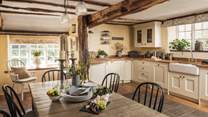 The gorgeous country kitchen with beams offers plenty of space for entertaining.