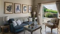 Inside you'll find a warm welcome in its living area, decorated in soothing tones of ocean blue