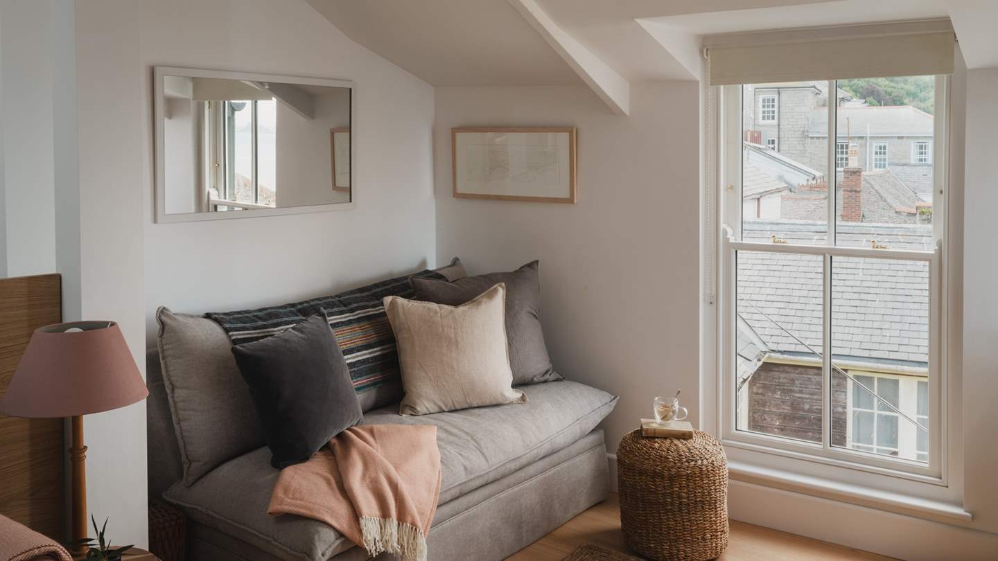 In the study, a comfy three-seater sofa boasts mesmeric views across the sea towards St Michael’s Mount