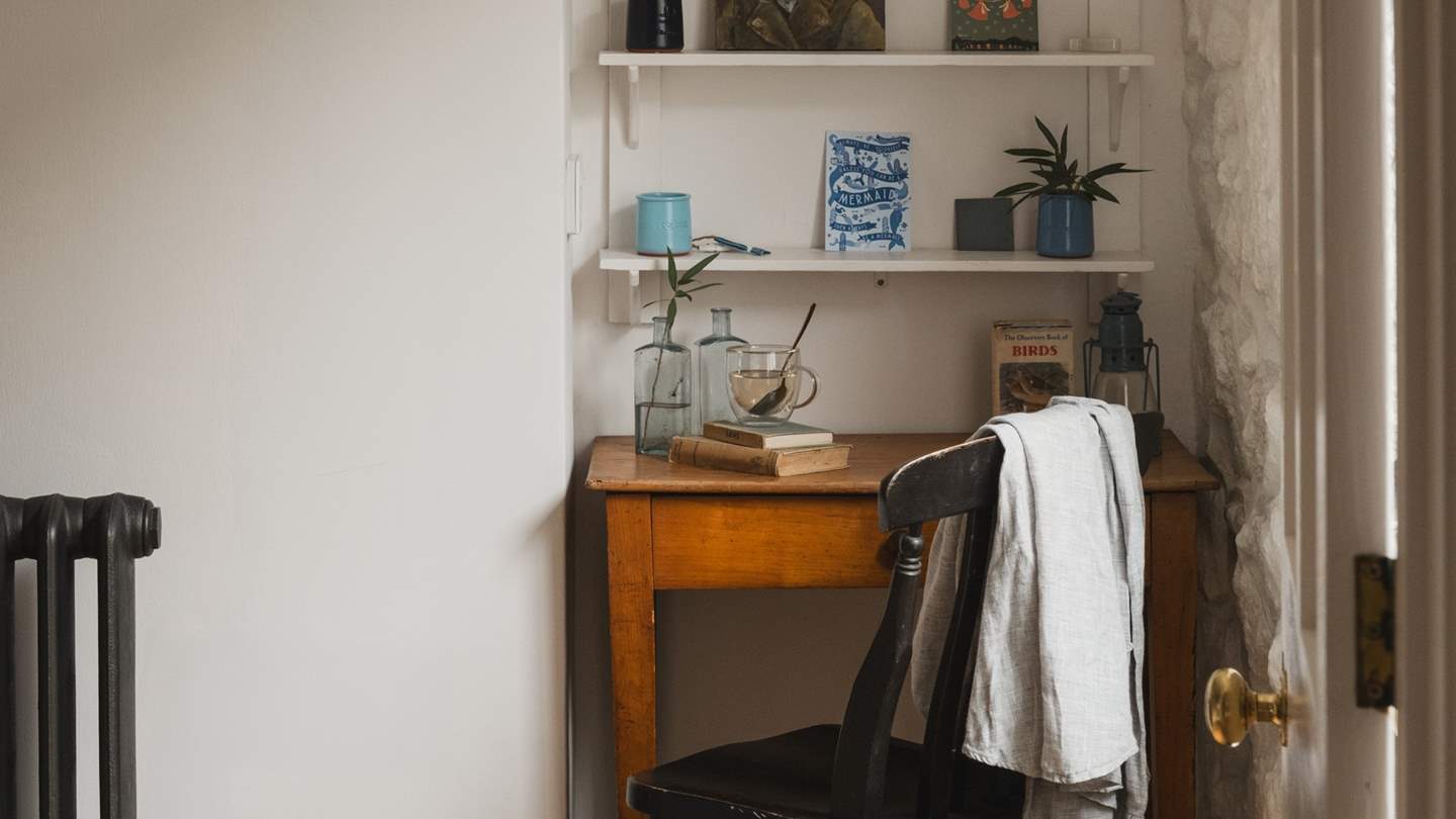 Final touches, such as the vintage Lloyd Loom chair and rustic feature mirror, tie the room together perfectly, offering a serene space in which to unwind