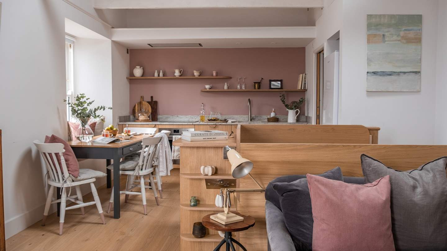 High-beamed cathedral ceilings and oak flooring offer a calming space in which to unwind, while neutral tones blend effortlessly with with touches of blushed accents bringing a sumptuous warmth to the room