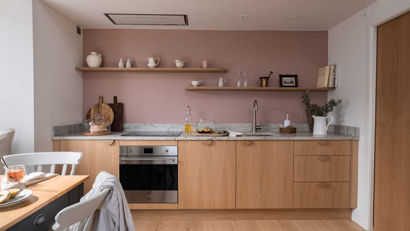 The bespoke oak kitchen is a culinary dream, whether you love waking to the aromas of freshly made Nespresso coffee or crafting a wholesome feast with the built-in SMEG oven and induction hob