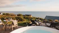 The dreamy hot tub provides a serene spot to sit back and watch the rhythm of the sea