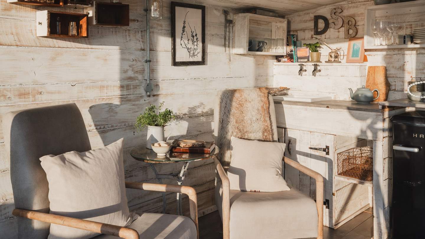 The summer house comes complete with a super-sweet retro fridge, sink with running water, kettle and two sweet seats