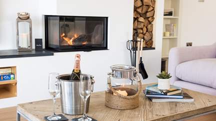 Gather on the beautiful Loaf furniture and watch the delightful wood burning stove