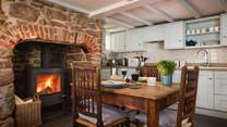 The wonderful, cosy kitchen with original fireplace is made for decadent dinners and lazy lunches.