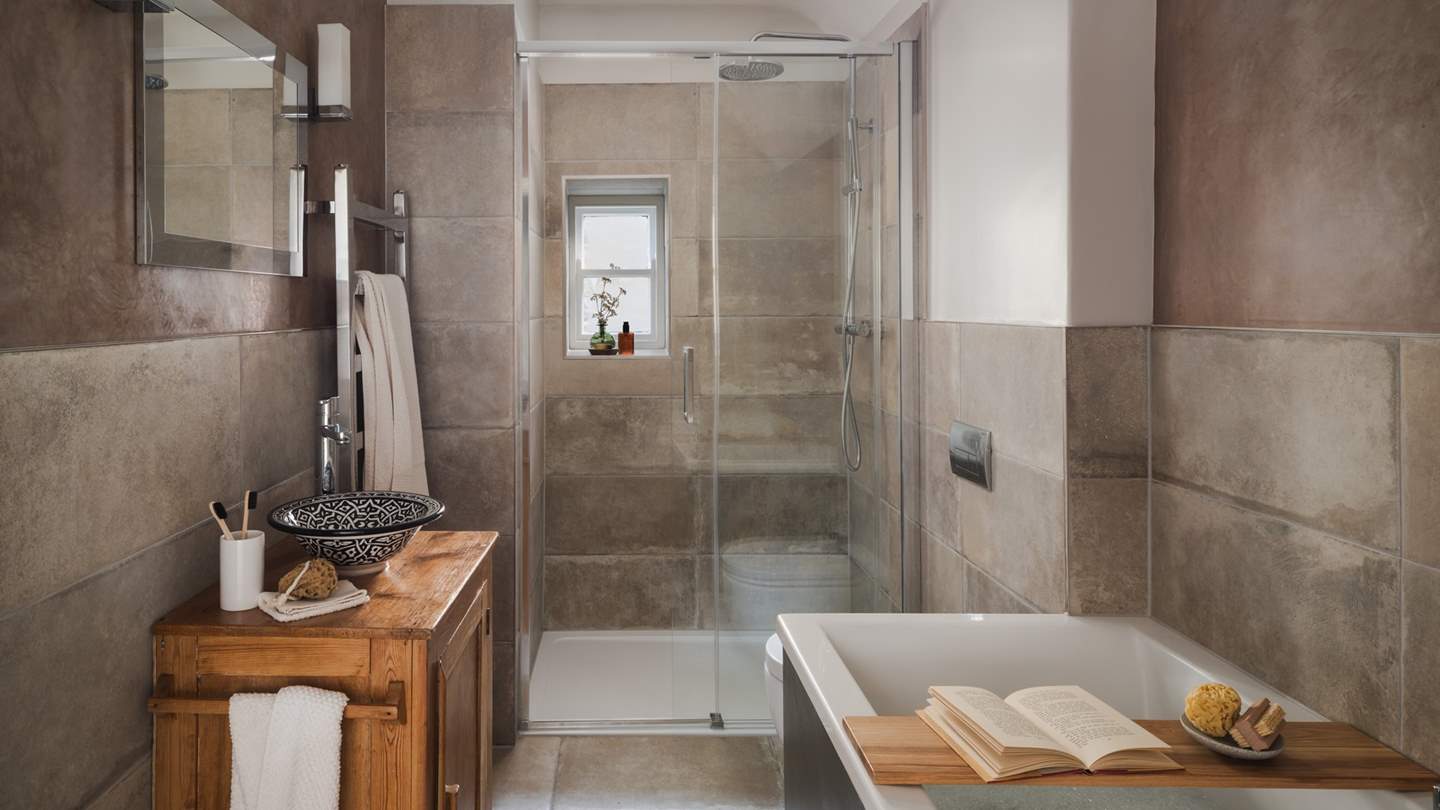 The earth-toned bathroom, with Moroccan polished plaster walls inspired by far-flung travels