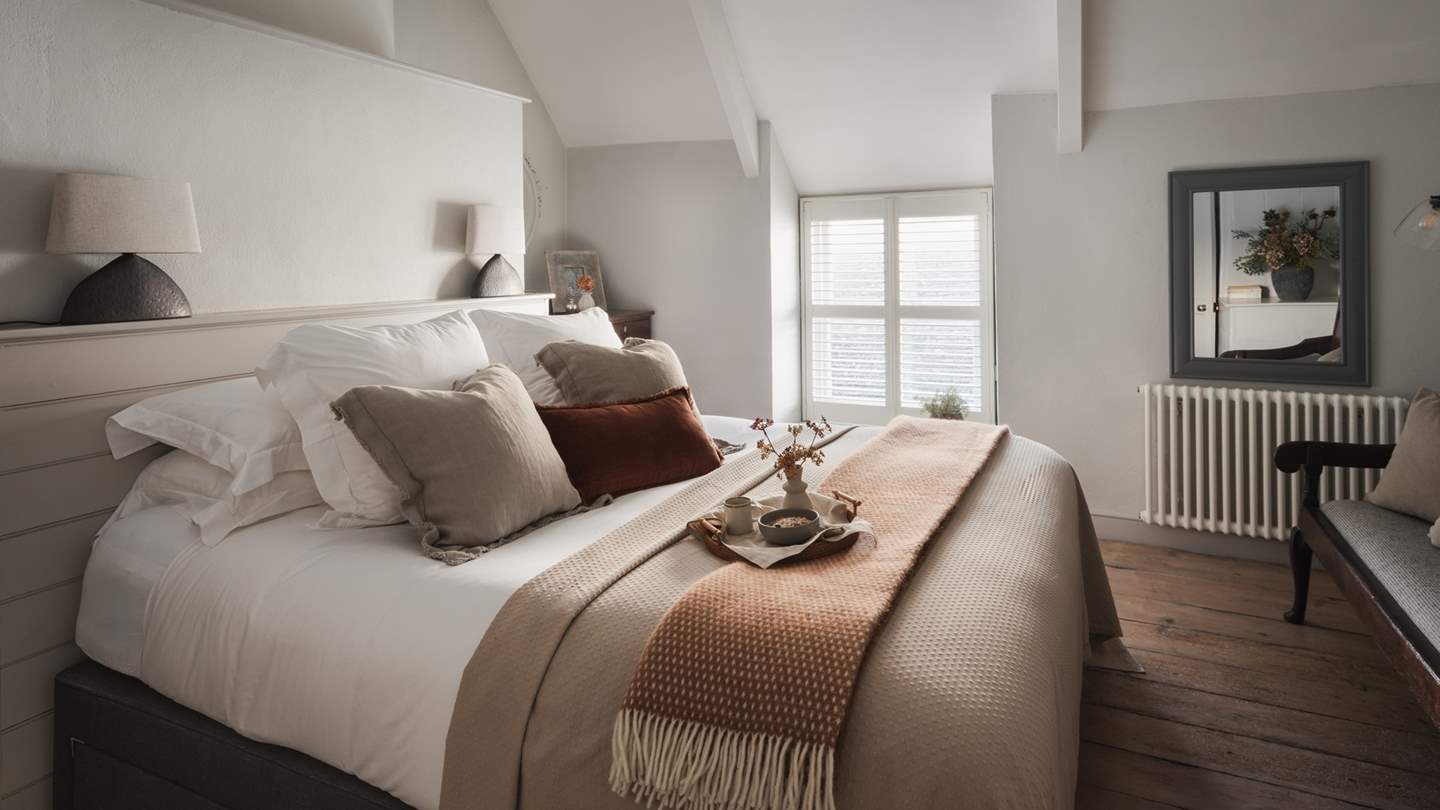 Upstairs two beautiful bedrooms dressed in soul-soothing hues reside