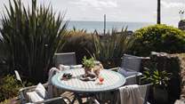 Step outside to uncover a beautiful sea terrace to the front of the property...