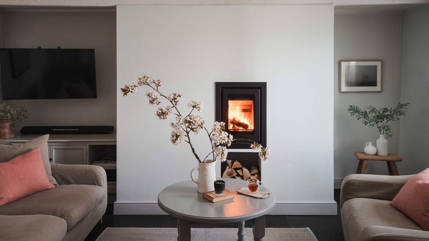 Step into the calming living space, where sleek, modern touches blend beautifully with beamed ceilings and a traditional, panelled wall