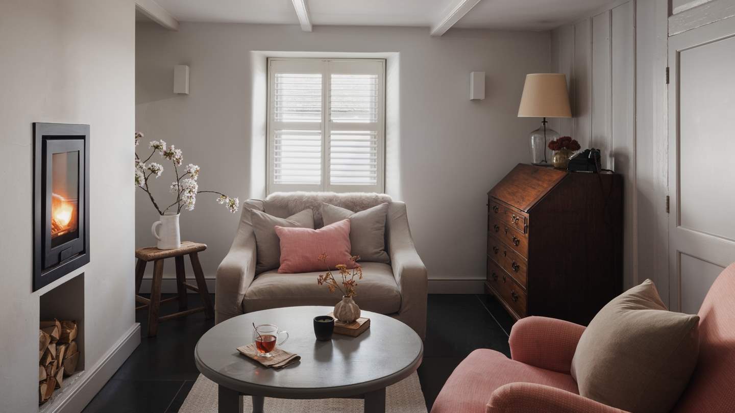 At the heart of the room sits a contemporary wood burning stove, with the addition of a comfortable sofa, armchair and loveseat