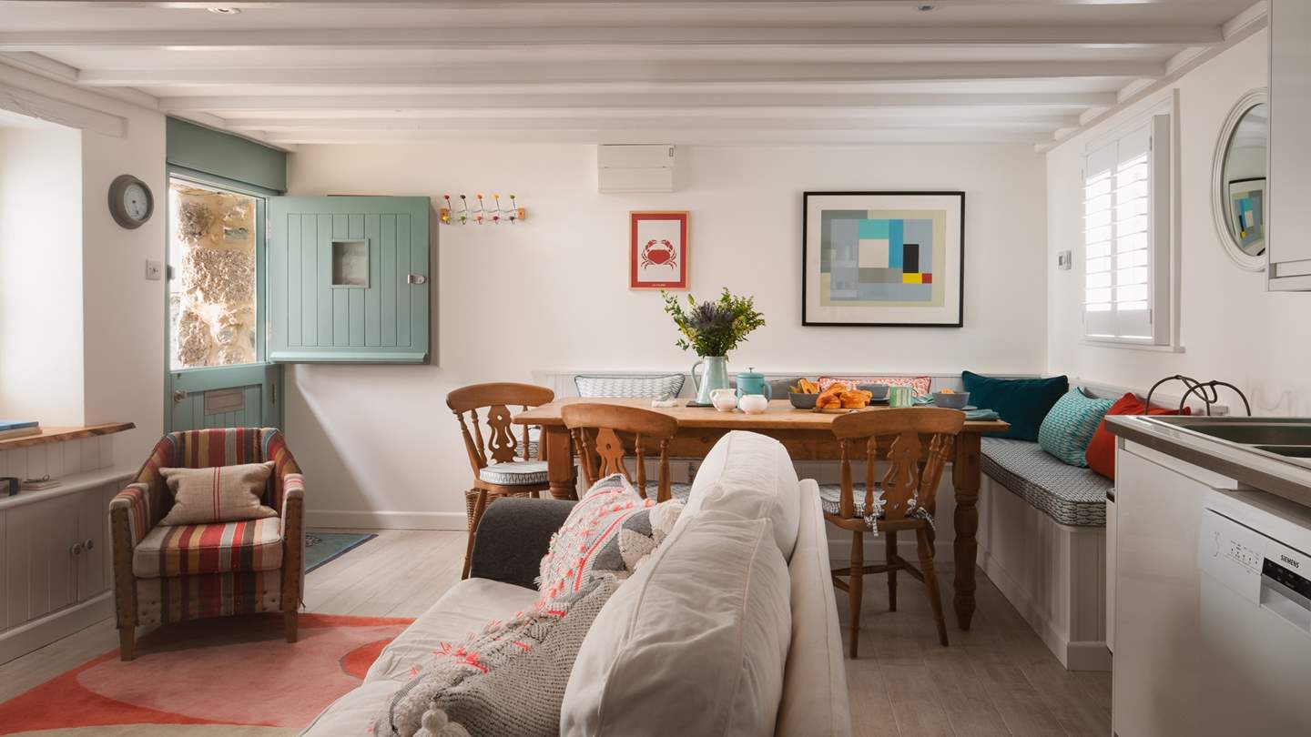 The charming open plan living space thoughtfully decorated with boldly coloured interiors paired with rustic furnishings 