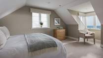 The third bedroom also lies on the first floor with stunning sea views and king-sized bed and chest of drawers 