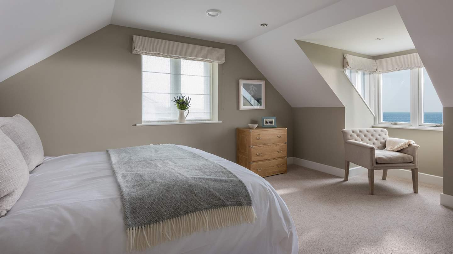 The third bedroom also lies on the first floor with stunning sea views and king-sized bed and chest of drawers 