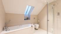 The family bathroom with bath and shower and underfloor heating to keep you cosy 