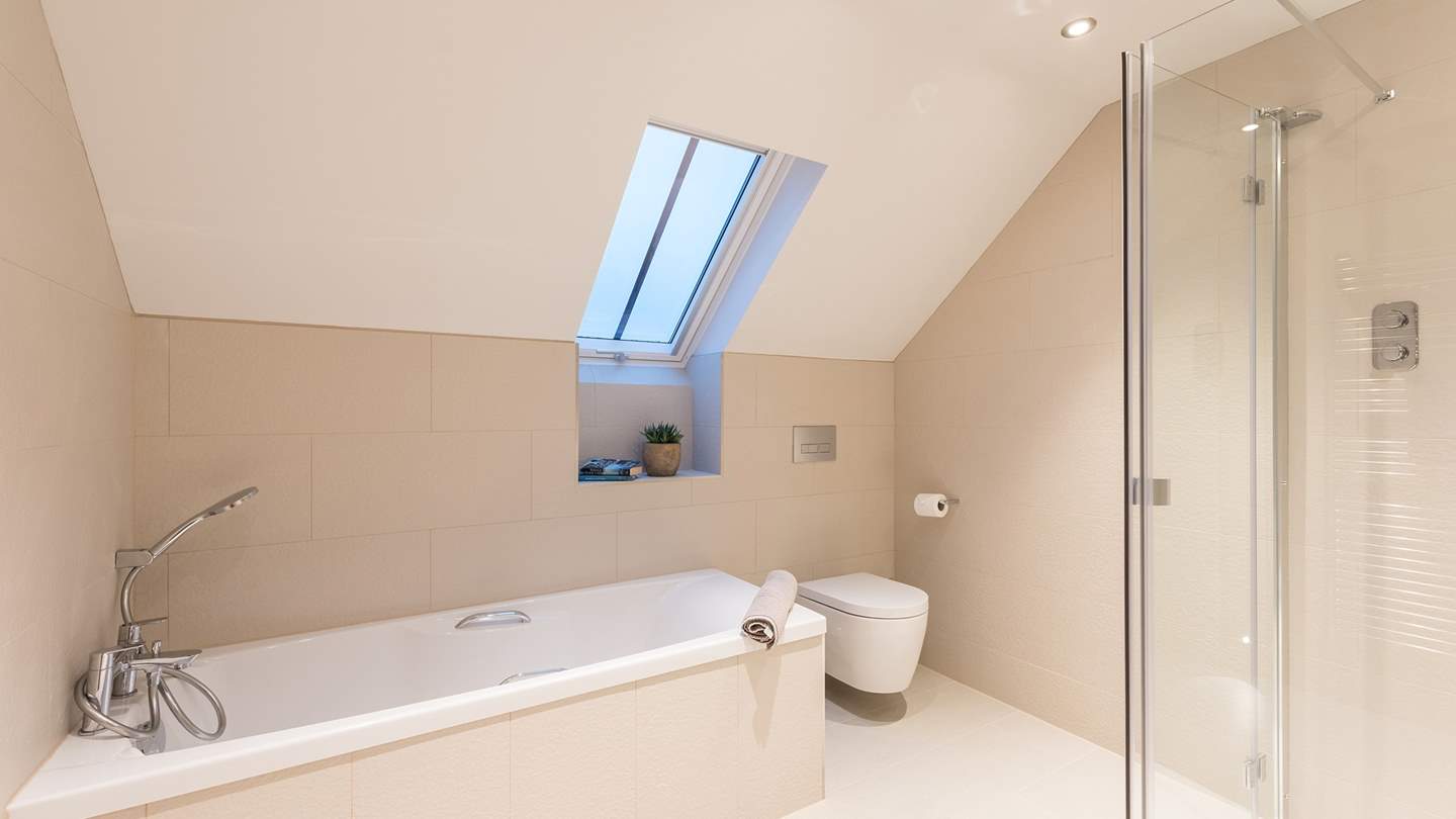 The family bathroom with bath and shower and underfloor heating to keep you cosy 
