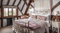 An original RW Winfield antique king size brass bed completes this romantic hideaway perfectly.