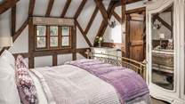 High vaulted ceilings give the master bedroom a light, airy feel whilst the gorgeous beams keeps it all very vintage!