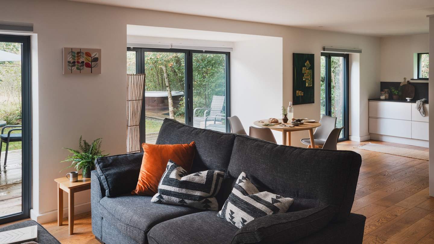 Gaze over the surrounding wildlife from the comfort of the plump grey sofa