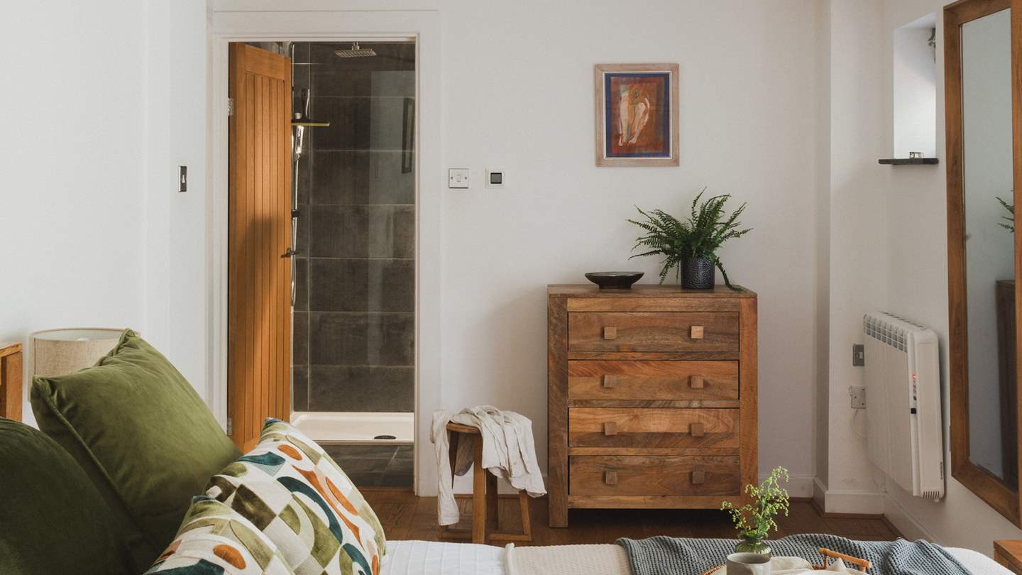 Adjacent is the en suite with underfloor heating and a walk-in shower