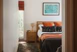 Discover charcoals and burnt oranges in the darling second bedroom...