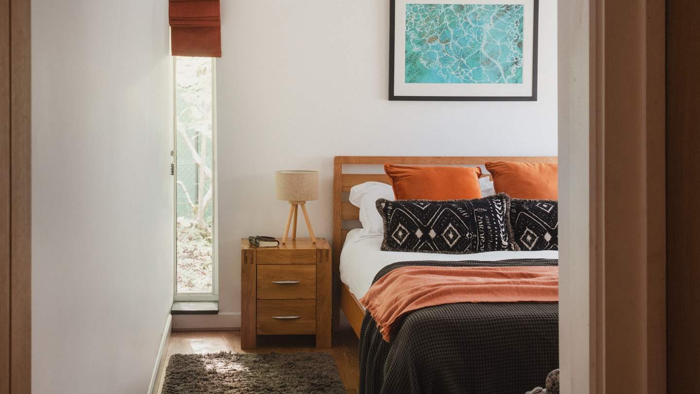 Discover charcoals and burnt oranges in the darling second bedroom...