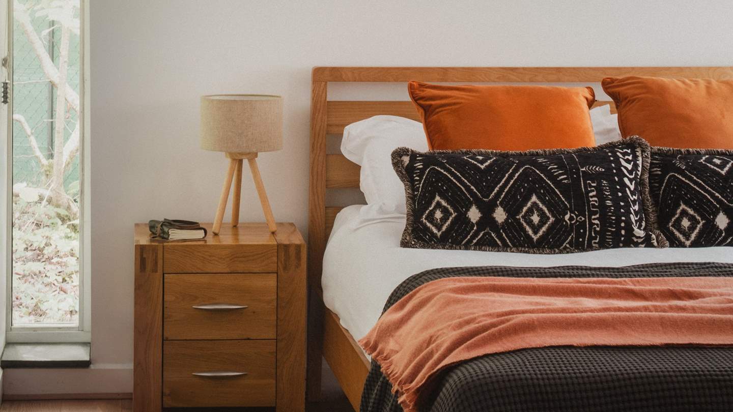 This beautiful bedroom enjoys direct access to a private deck with a table and chairs